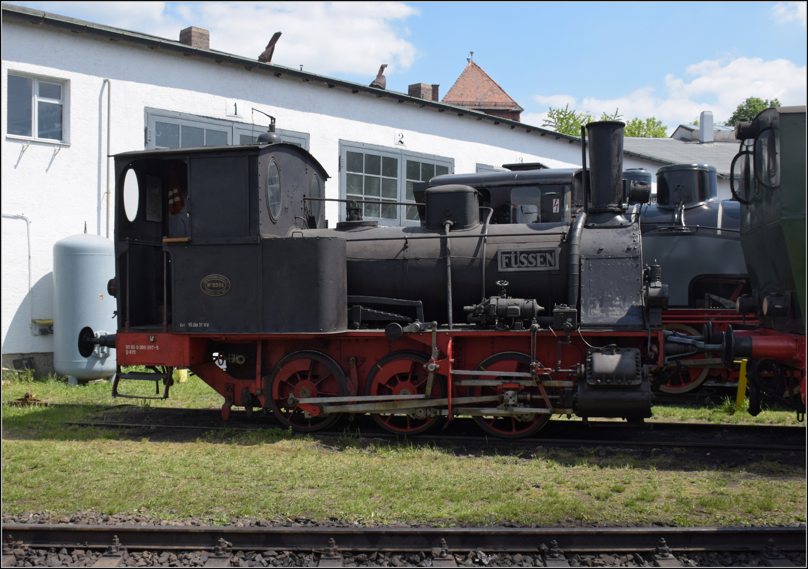 175 Jahre Eisenbahn in Nördlingen / 55 Jahre Bayrisches Eisenbahnmuseum.

Die Lok Nr. 7 'Füssen' war bis zum Fristablauf 2019 mit 130 Jahren die älteste betriebsfähige deutsche Dampflok. Sie wurde für die Lokalbahn Bissenhofen-Füssen gebaut. Unter den ganzen Dampflokriesen, selbst gegenüber anderen C-Kupplern wirkt sie wie eine Spielzeugeisenbahn, steht aber trotzdem auf 1435 mm-großem Fuß. Die Optik täuscht nicht, denn recht bald erwiesen sich die vier Schwestern auf der Lokalbahn zu schwach und wurden andernorts verwendet. Nachdem das Problem auch auf der Strecke Fürth-Cadolzburg auftrat, fand sie auf der württembergischen Strecke Niederbiegen-Weingarten ein Auskommenm insbesondere, weil die Papierfabrik in Baienfurt für einen regelmäßigen Güterverkehr sorgte, auch werksintern. Seit 2002 fuhr sie regelmäßig für das bayerische Eisenbahnmuseum und gehört der Einrichtung seit 2009. Mai 2024.