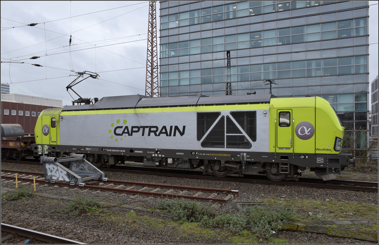 248 037 von Captrain bringt einige Blechrollen nordw�rts. Duisburg, Februar 2026.