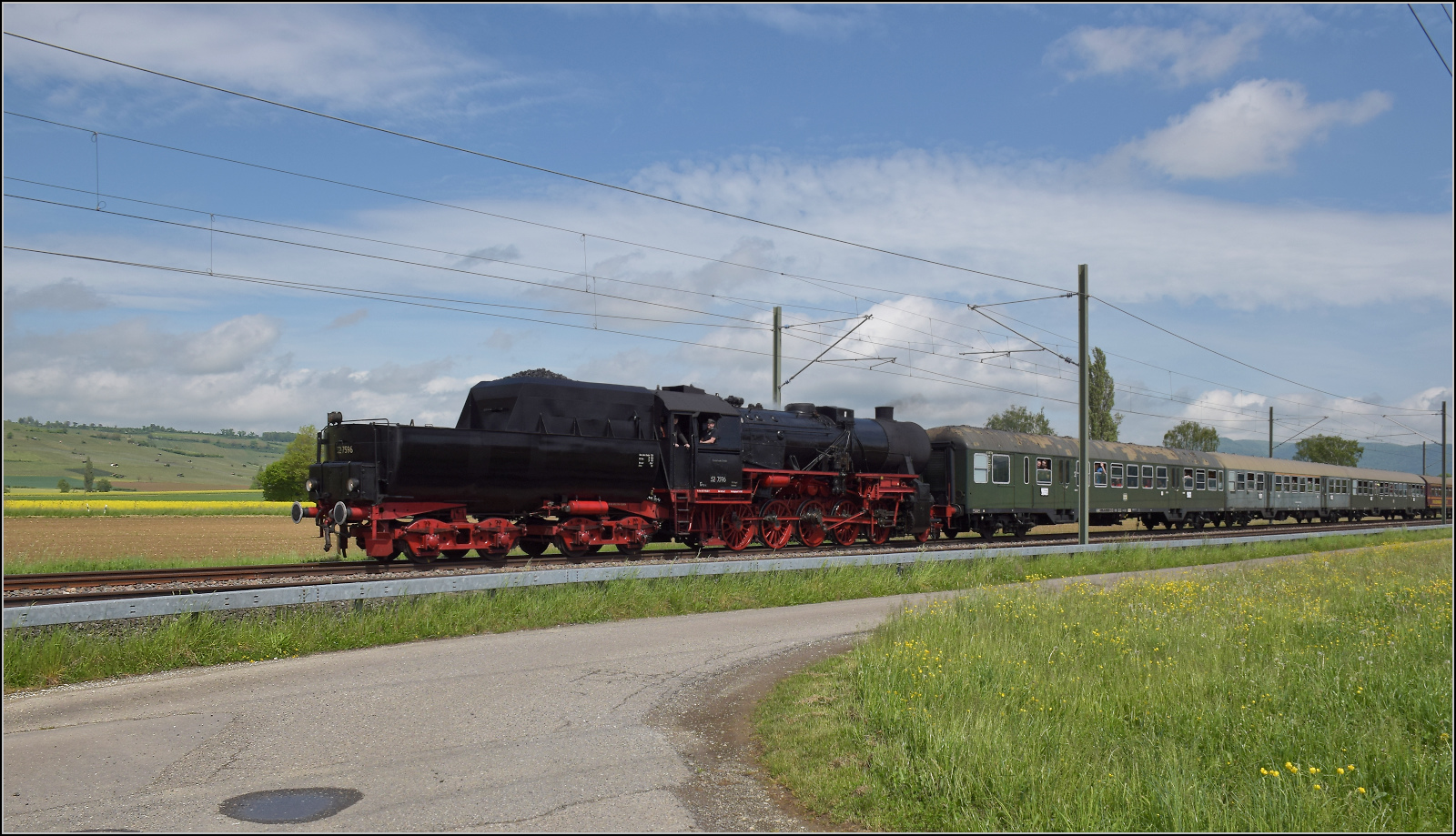 Abschiedfahrten von 52 7596.

Bei Wilchingen-Hallau befindet sich der Zug in der Schweiz. Mai 2025.