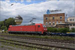 
185 302 mit einem Neuwagenpark in Weinheim. Juli 2023.