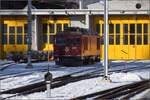 Die bereits etwas betagte Zweikraftlok Gem 4/4 801 aus dem Jahr 1966 vor dem Fahrzeugschuppen in Pontresina. Januar 2023.